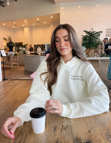 Cozy Cream Hoodie with Inspirational Bible Verse Genesis 1:27